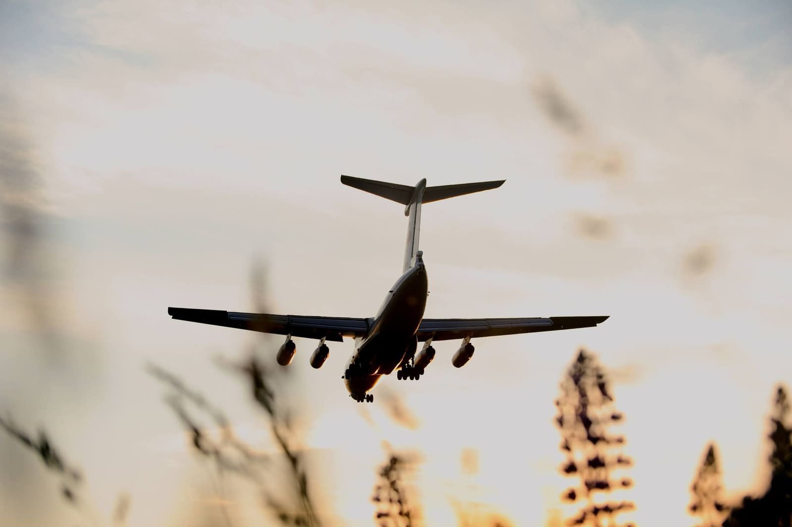 Cargo aircraft in flight at sunset