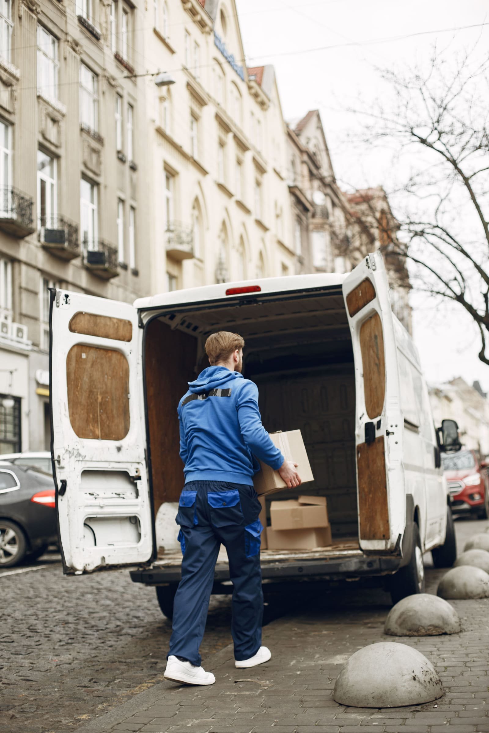 Courier loading parcels for door-to-door delivery